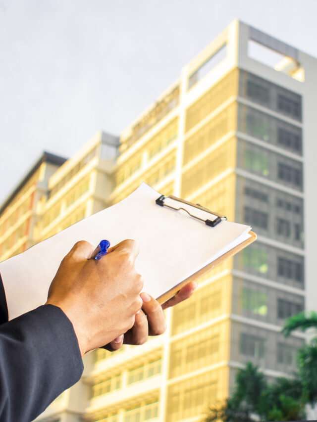 Man business salesman sell dominium writing notepad on blurry background.For home business contracting or agreement and home warranty image.